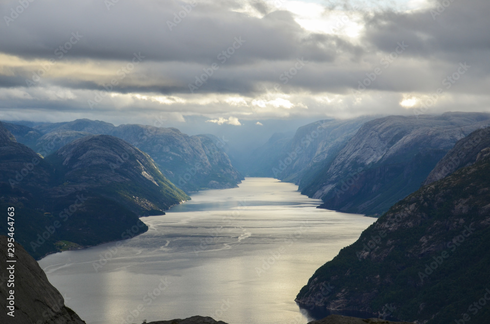 Magical scenic view from the cliff Preikestolen In the Norwegian mountains. Fjord and mountains.