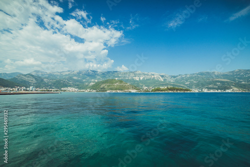 Adriatic coast in summer. The height of the tourist season. Transparent warm sea and mountains. Montenegro.