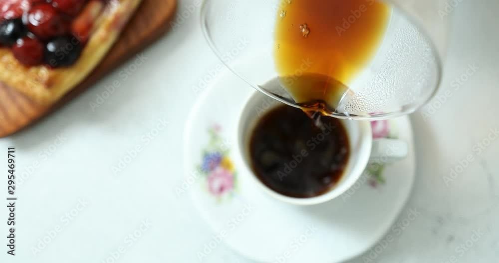 Pouring flannel drip coffee in classy cup on table