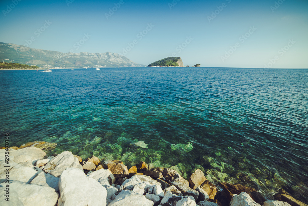 Adriatic coast in summer. The height of the tourist season. Transparent warm sea and mountains. Montenegro.