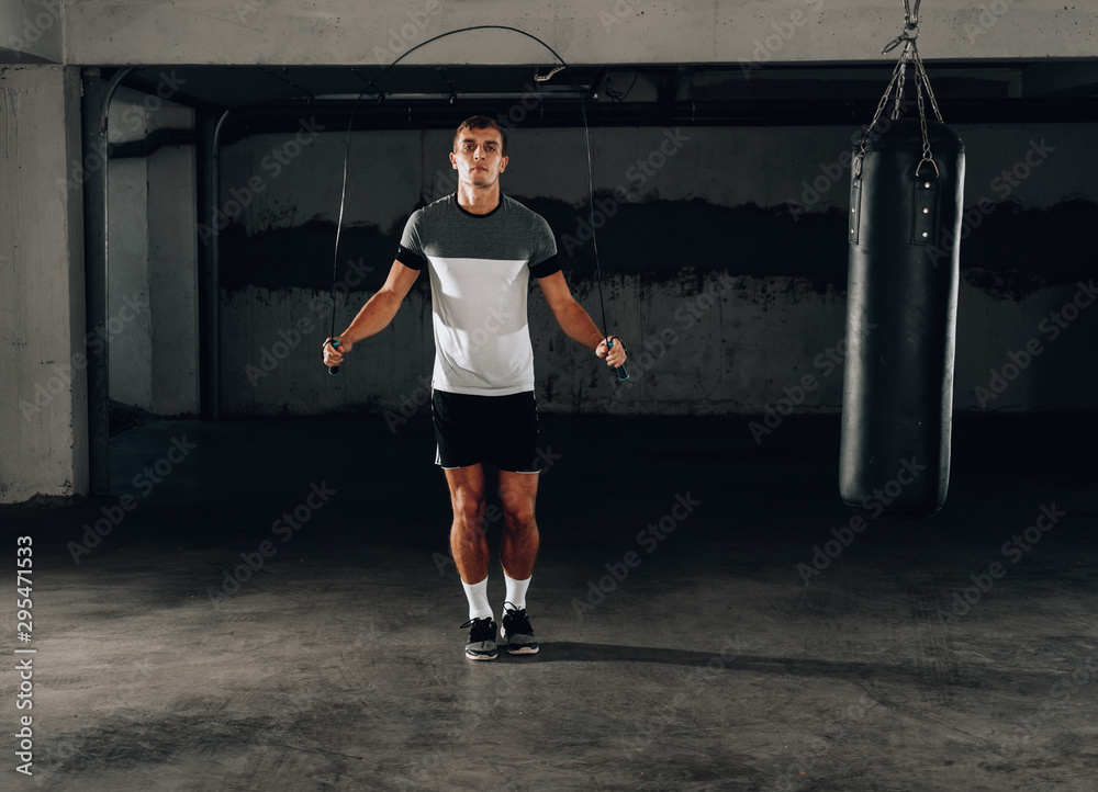 Portrait of young male athlete skipping rope Portrait of young male athlete skipping rope