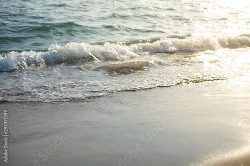 Wave in the sea in sunset time by the beach.