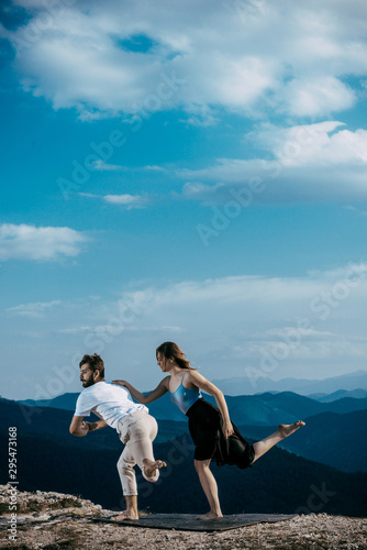 Two people dancing in contemporary stile of ballet at mountain peak