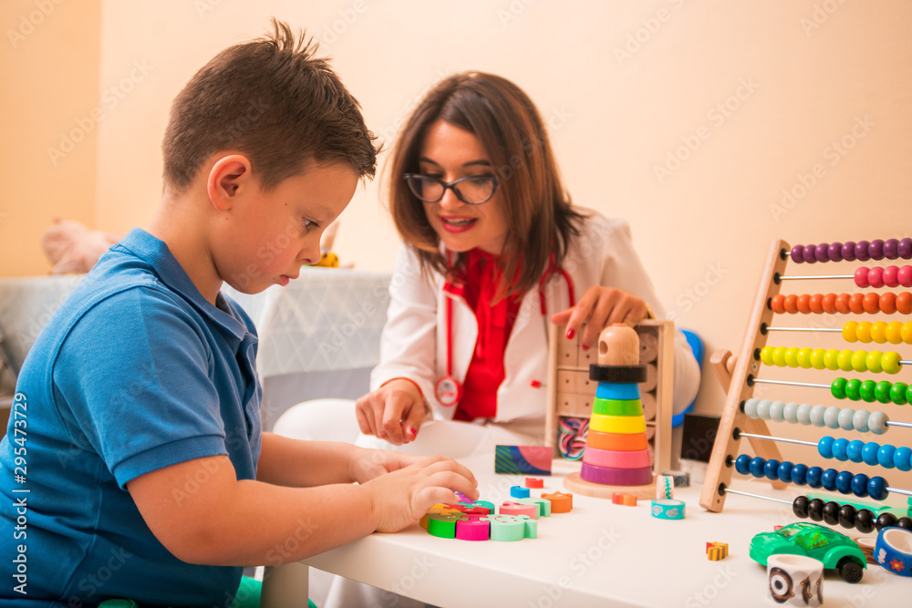 Doctor and young boy play with toys at doctor's office Doctor and young boy play with toys at doctor's office