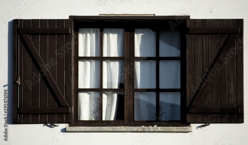A white facade with an open window