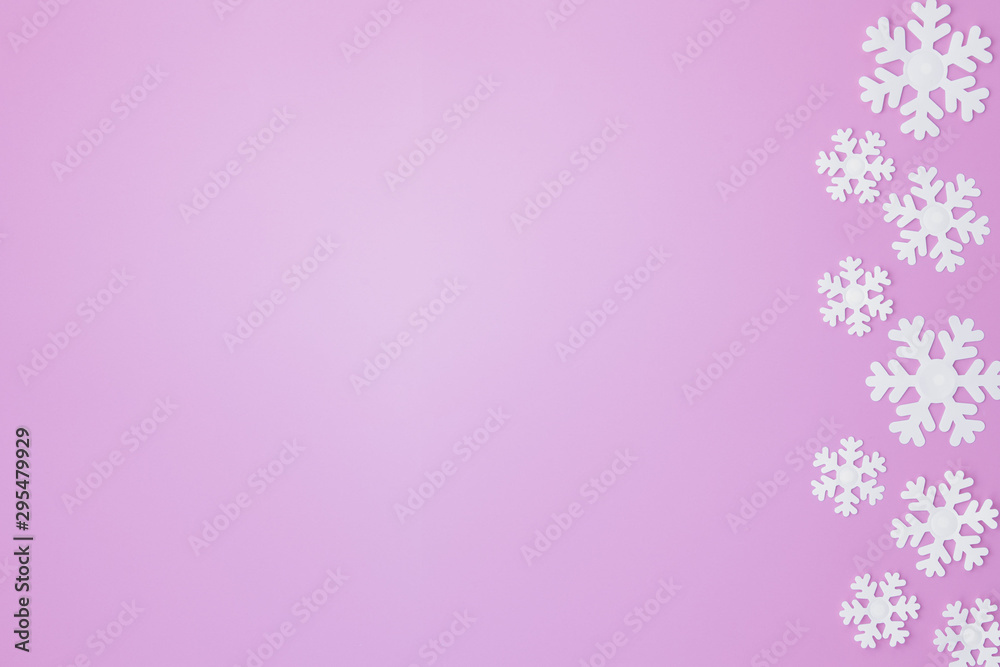 Winter pattern made of snowflakes and on pink background. Christmas concept. Flat lay. Copy space for your text Winter pattern made of snowflakes and on pink background. Christmas concept. Flat lay. Copy space for your text