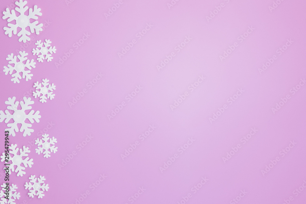 Winter pattern made of snowflakes and on pink background. Christmas concept. Flat lay. Copy space for your text