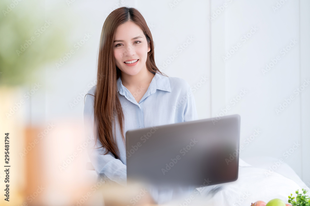 beautiful asain attractive female causual dress working with laptop on bed work at home ideas concept beautiful asain attractive female causual dress working with laptop on bed work at home ideas concept
