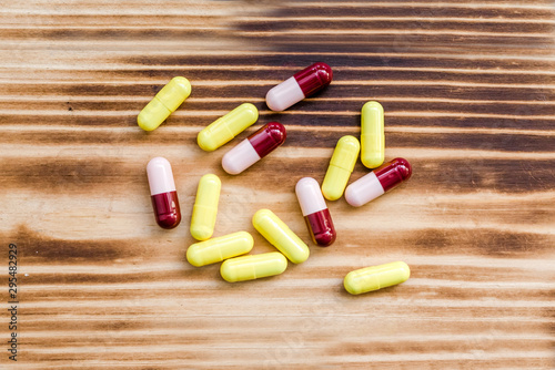 Medical pills on wooden background