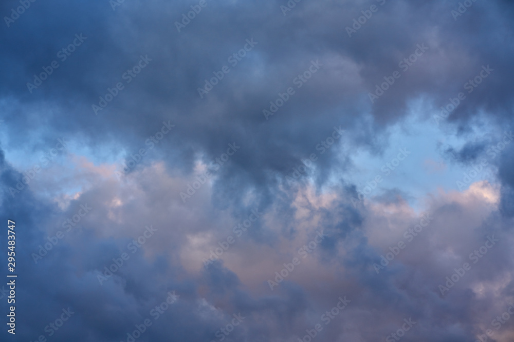 Dark big clouds. Dark and formidable clouds and the sky is visible in the middle. Dark big clouds. Dark and formidable clouds and the sky is visible in the middle.