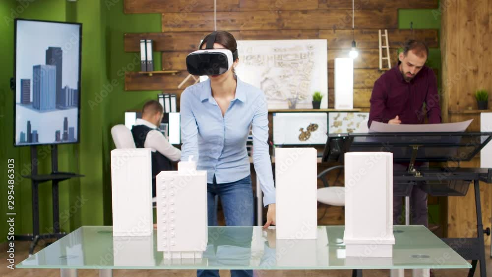 Female architects exploring virtual reality project of business buildings