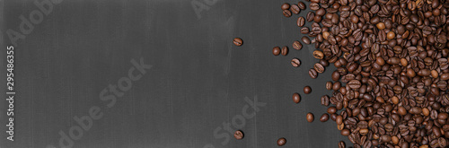 Coffee beans on black handmade painted background. Top view, Flat lay.