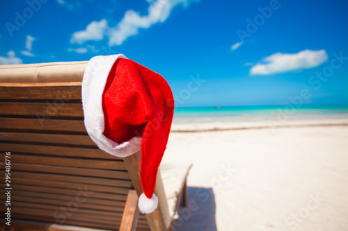 Santa hat on chair longue at tropical caribbean beach