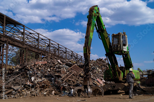  Dnipro, Dnepropetrovsk region / Ukraine - 01/10/2019; Loading scrap metal into wagons with a hydraulic manipulator.
