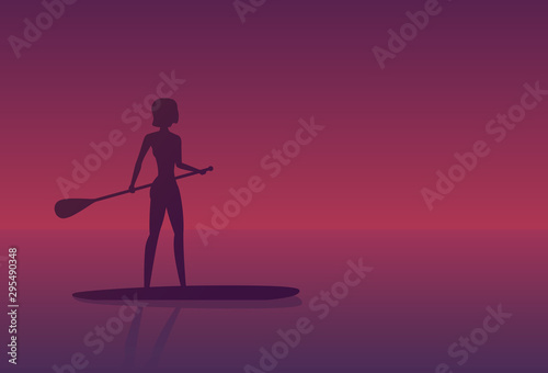 Girl on a sup board at sunset