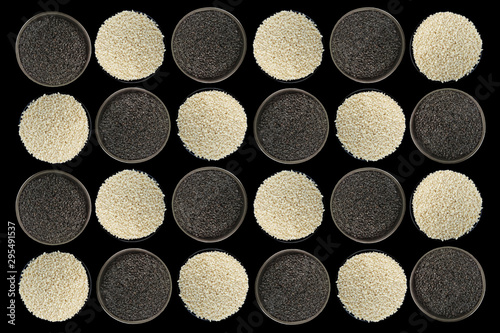 White sesame, black sesame seeds in a black bowl on black background