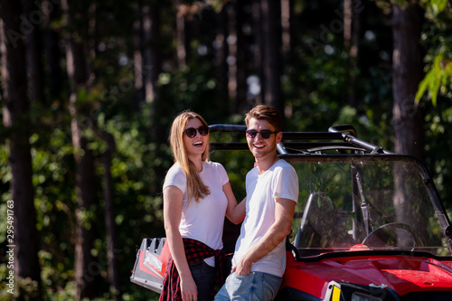 young couple driving a off road buggy car