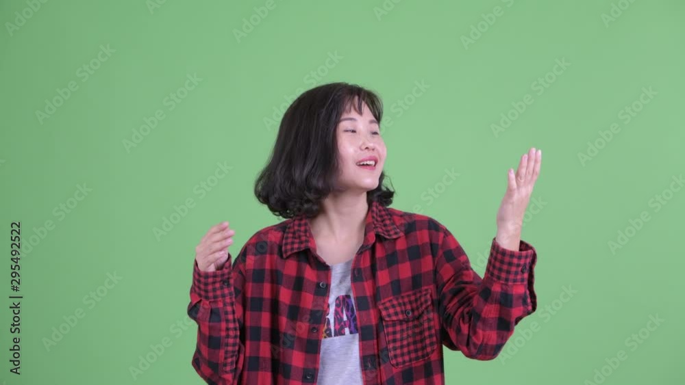 Happy Asian hipster woman catching something Happy Asian hipster woman catching something