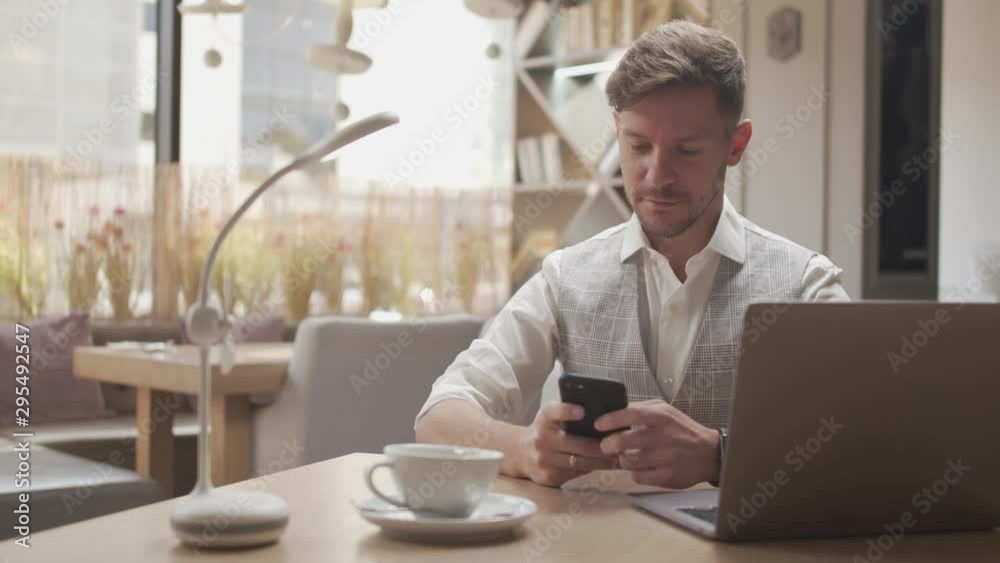 Businessman sitting and working in a cafe. Man using computer devices. Business and entrepreneurship. Businessman sitting and working in a cafe. Man using computer devices. Business and entrepreneurship.