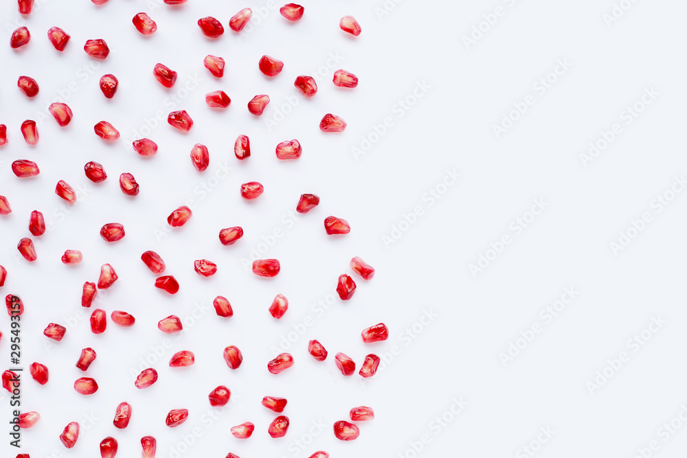 Pomegranate seeds on white background.