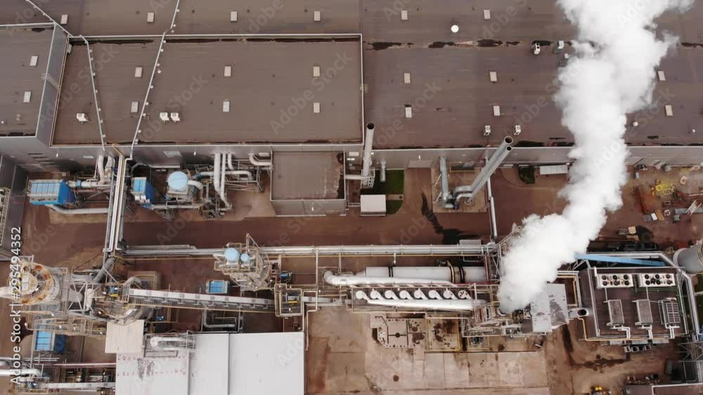 Wood processing plant pollutes the air with smoke coming from the pipe