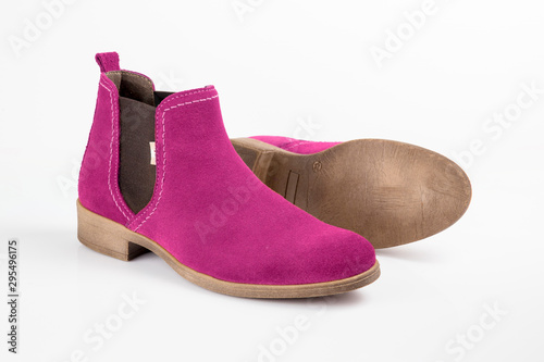 Female pink leather boots on white background, isolated product.