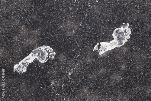White footprints on asphalt road