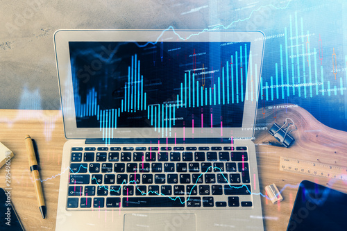 Double exposure of forex graph and work space with computer. Concept of international online trading. © peshkova