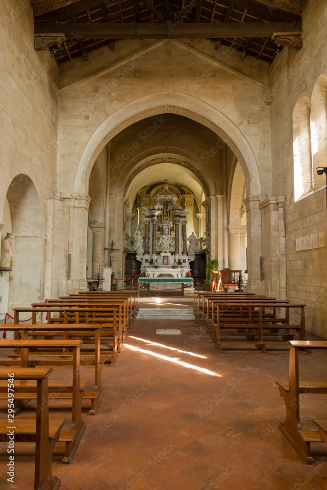 San Quirico d'Orcia, Siena / Italy-September 20 2018: Interior of the Collegiate church of San Quirico in the Romanesque style located in the medieval Tuscan village of San Quirico d'Orcia