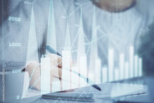 Forex chart displayed on woman's hand taking notes background. Concept of research. Multi exposure