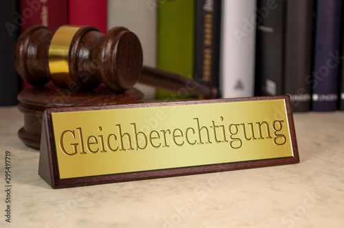 Golden sign with gavel and the german word for equality - gleichberechtigung on a desk