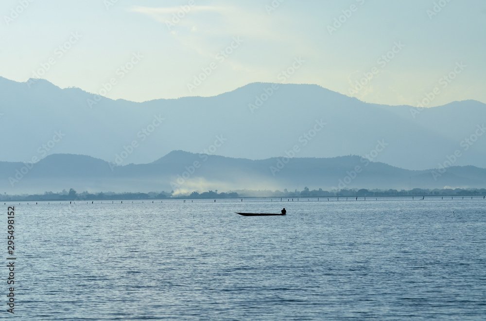 peaceful of lake with mountain view at Phayao lake in Thailand peaceful of lake with mountain view at Phayao lake in Thailand