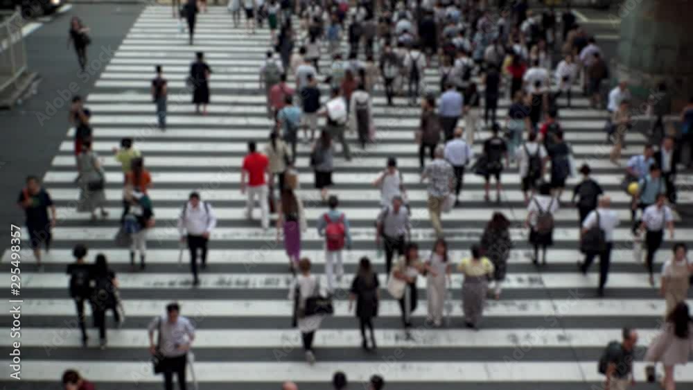 UMEDA, OSAKA, JAPAN - CIRCA SEPTEMBER 2019 : Aerial blurred high angle view of zebra crossing near Osaka train station. Crowd of people at the street. Shot in busy rush hour. Wide slow motion. UMEDA, OSAKA, JAPAN - CIRCA SEPTEMBER 2019 : Aerial blurred high angle view of zebra crossing near Osaka train station. Crowd of people at the street. Shot in busy rush hour. Wide slow motion.