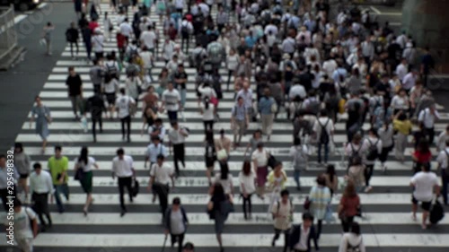 Wallpaper Mural UMEDA, OSAKA, JAPAN - CIRCA SEPTEMBER 2019 : Aerial blurred high angle view of zebra crossing near Osaka train station. Crowd of people at the street. Shot in busy rush hour. Wide slow motion. Torontodigital.ca