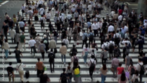 Wallpaper Mural UMEDA, OSAKA, JAPAN - CIRCA SEPTEMBER 2019 : Aerial blurred high angle view of zebra crossing near Osaka train station. Crowd of people at the street. Shot in busy rush hour. Wide slow motion. Torontodigital.ca