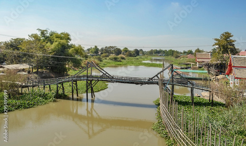 province Thailand, view of tipical house in suphanburi from the tipical wooden bridge. river of South East Asia. photo