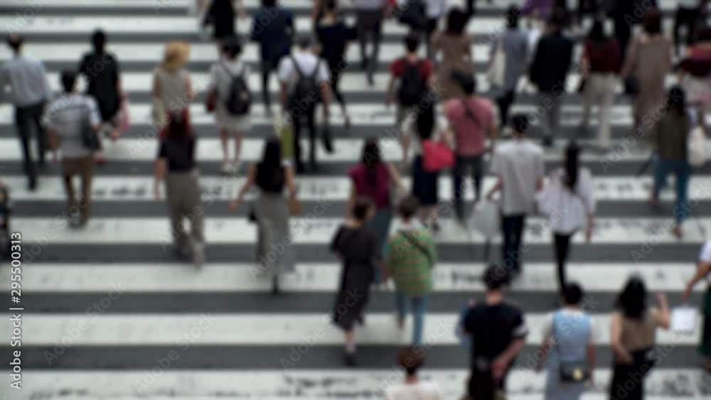 UMEDA, OSAKA, JAPAN - CIRCA SEPTEMBER 2019 : Aerial blurred high angle view of zebra crossing near Osaka train station. Crowd of people at the street. Shot in busy rush hour. Wide slow motion. UMEDA, OSAKA, JAPAN - CIRCA SEPTEMBER 2019 : Aerial blurred high angle view of zebra crossing near Osaka train station. Crowd of people at the street. Shot in busy rush hour. Wide slow motion.
