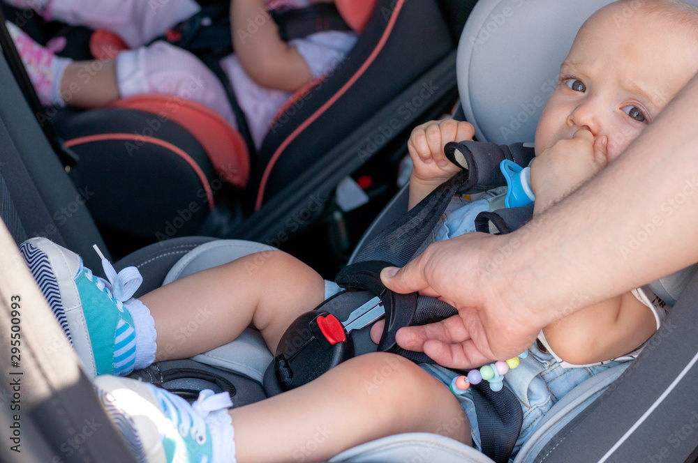 The process of fastening seat belts on a child restraint seat in the car. Safety for children, transport safety. The process of fastening seat belts on a child restraint seat in the car. Safety for children, transport safety.