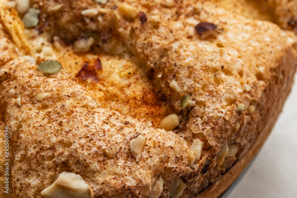 Sponge cake with apples, crushed walnuts and cinnamon, close-up Sponge cake with apples, crushed walnuts and cinnamon, close-up