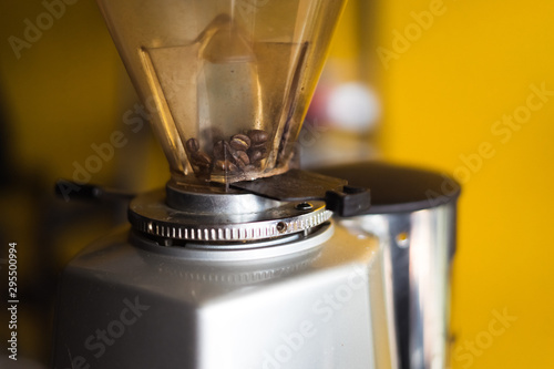 close-up fresh in coffee grinder prepare to mill , tool and machine background blur