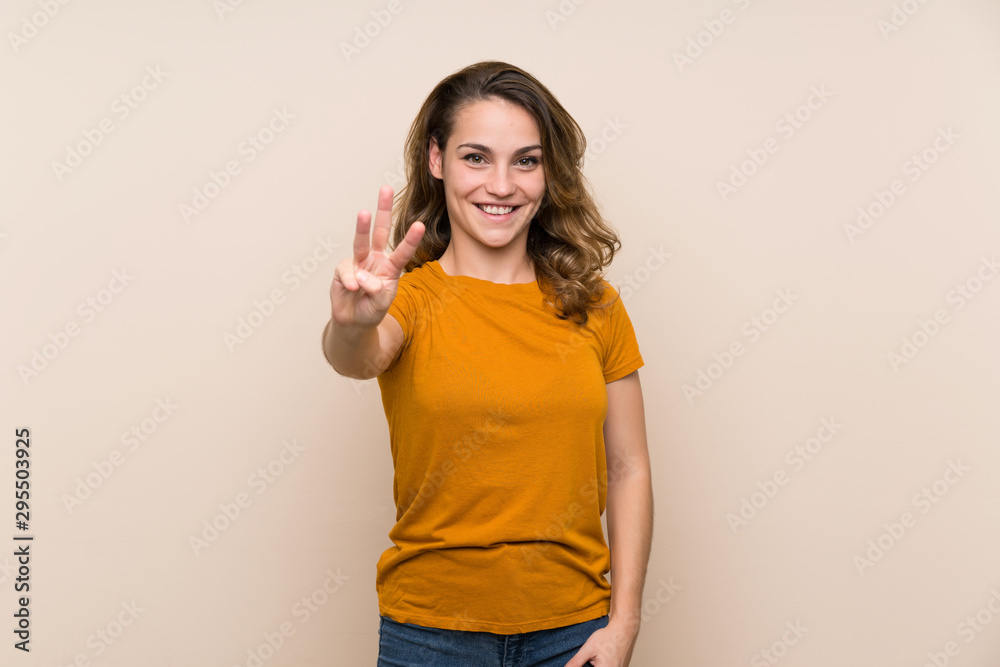 Young blonde girl over isolated background happy and counting three with fingers Young blonde girl over isolated background happy and counting three with fingers