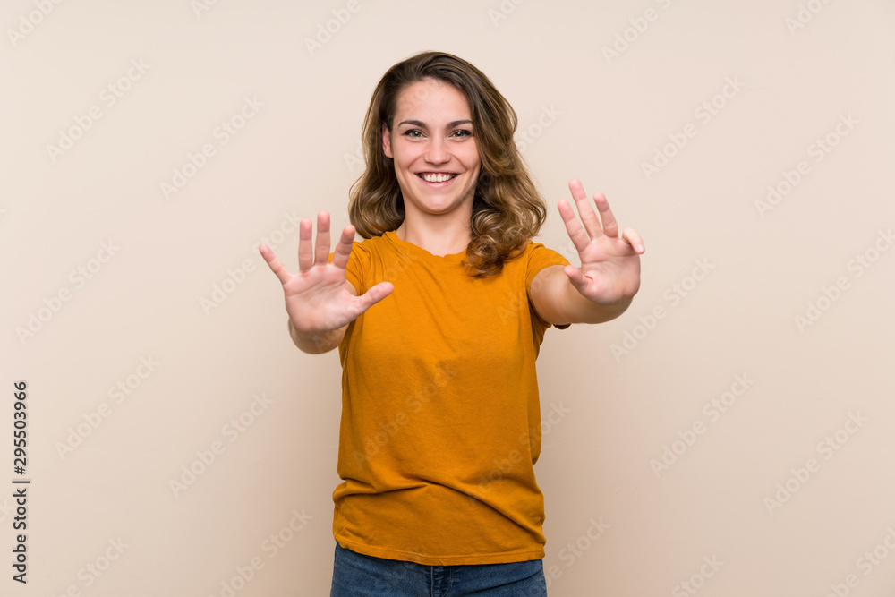 Young blonde girl over isolated background counting nine with fingers Young blonde girl over isolated background counting nine with fingers
