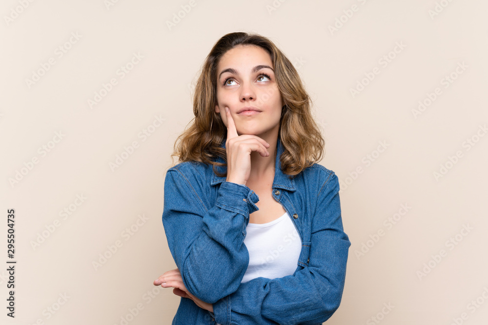 Young blonde woman over isolated background thinking an idea Young blonde woman over isolated background thinking an idea