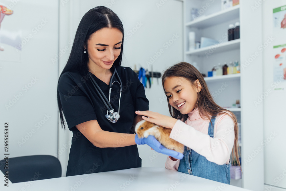 Doctor in black uniform, small daughter with their chinchilla pet at veterinary. Love for pets. Doctor in black uniform, small daughter with their chinchilla pet at veterinary. Love for pets.