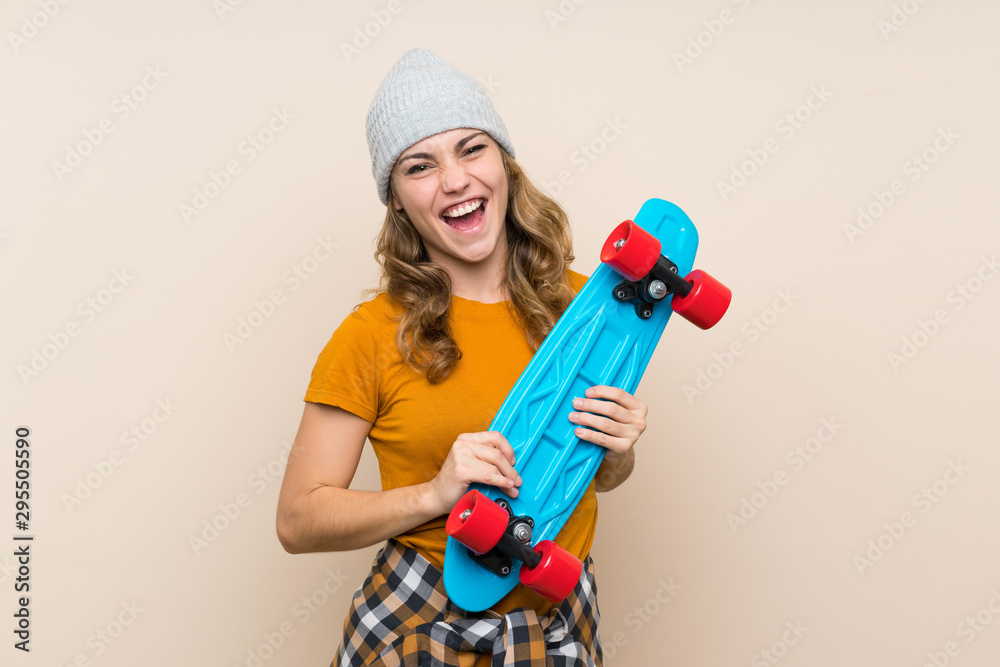 Young skater blonde girl over isolated background Young skater blonde girl over isolated background