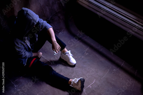 Fotografija Drugged woman sitting on the floor with substance abuse, substance abuse, addiction, people and drug use concept, copy space background for text