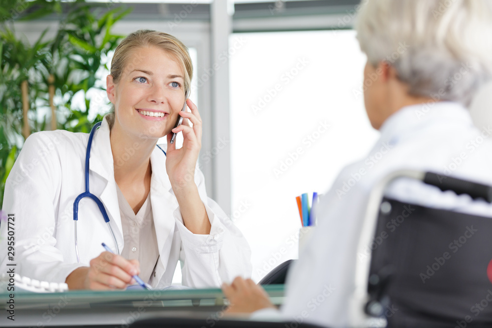 female doctor on the phone talking to her senior woman female doctor on the phone talking to her senior woman
