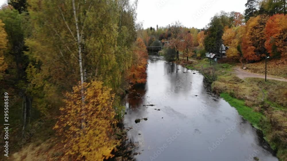 aerial view flying over autumn river near village in Russia with bridge and bungee aerial view flying over autumn river near village in Russia with bridge and bungee