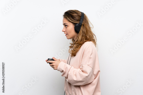 Young blonde woman playing at videogames