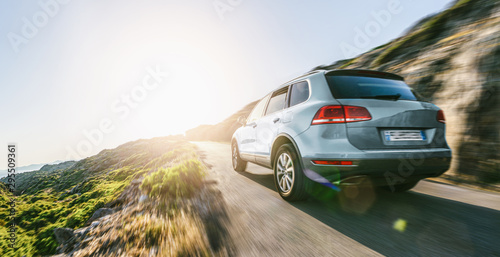 SUV car in spain mountain landscape road at sunset photo